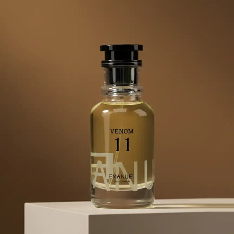 A clear glass bottle of emanuel venom 11 eau de toilette with a black cap and minimalist label design.