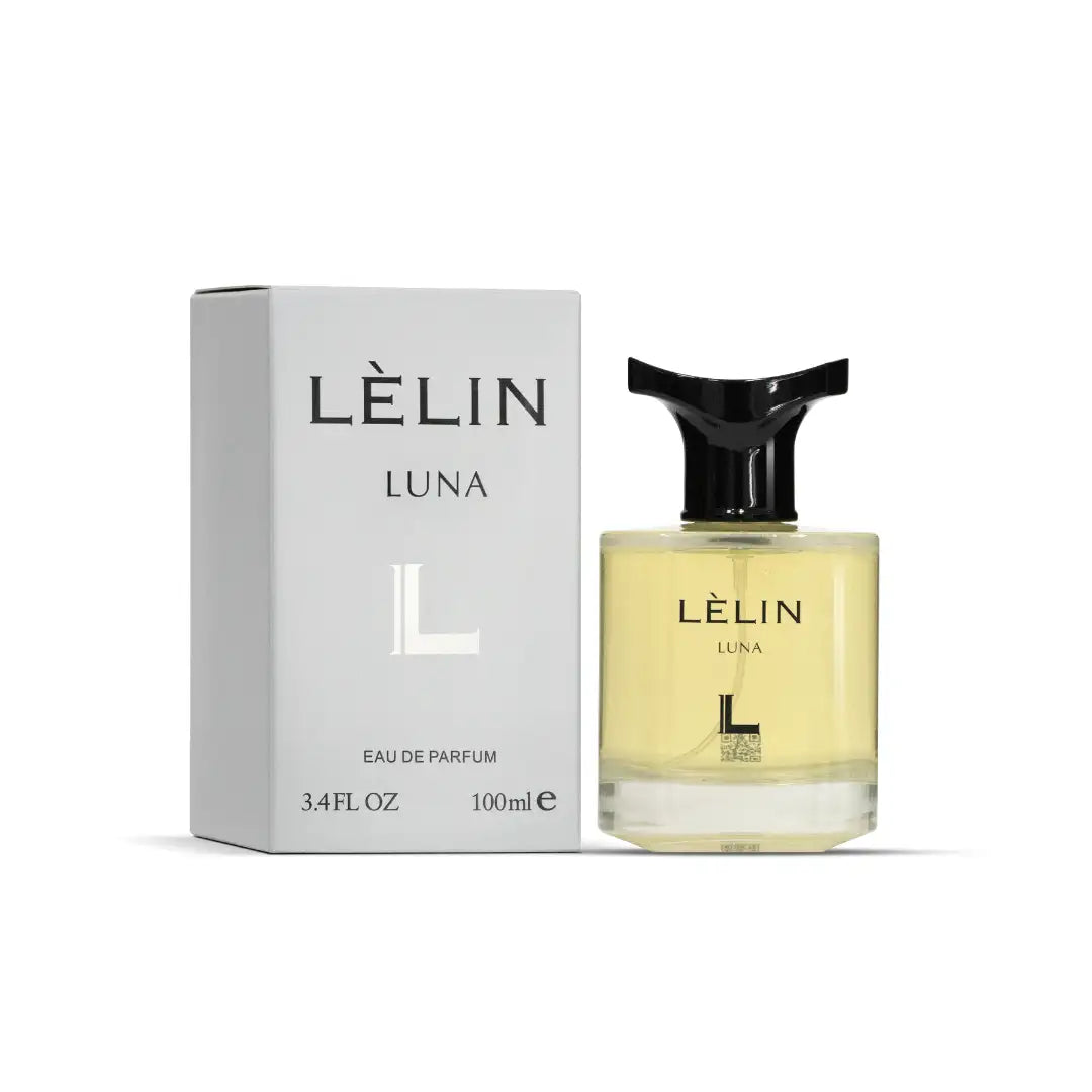 L’élin luna eau de parfum in a clear glass bottle with a black, sculpted cap and pale yellow liquid.