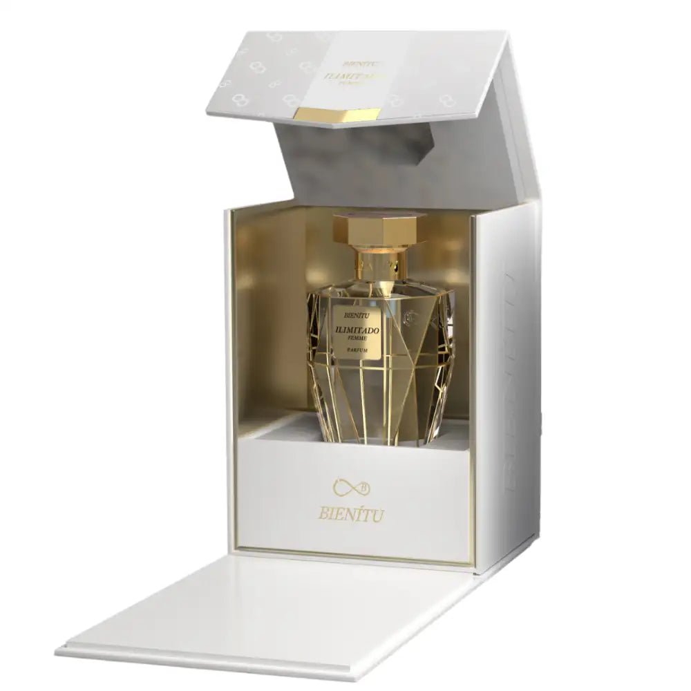 A luxurious gold-toned perfume bottle with a faceted, geometric design and an octagonal cap sits elegantly inside its white gift box.